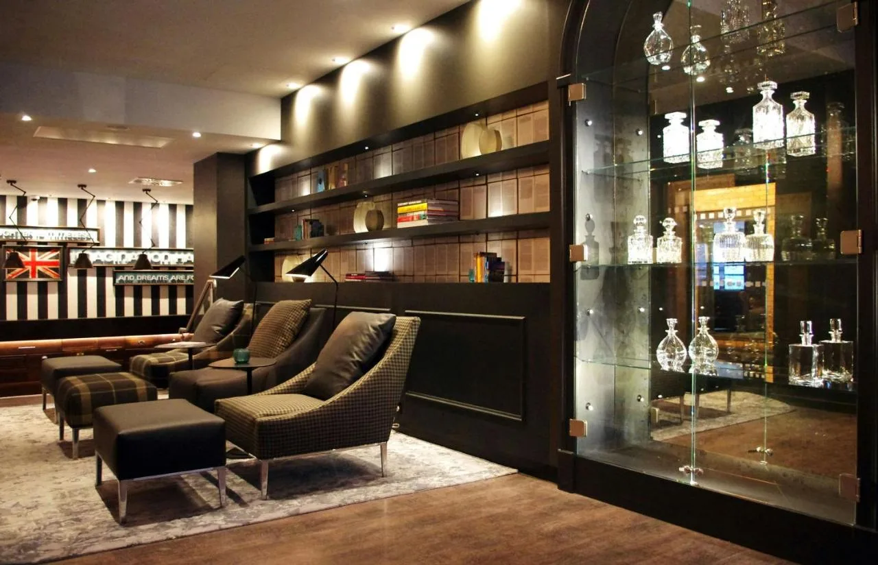 a bar with couches and chairs in a room at Motel One Newcastle in Newcastle upon Tyne